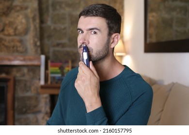 Man using nose hair trimmer at home - Shutterstock ID 2160157795