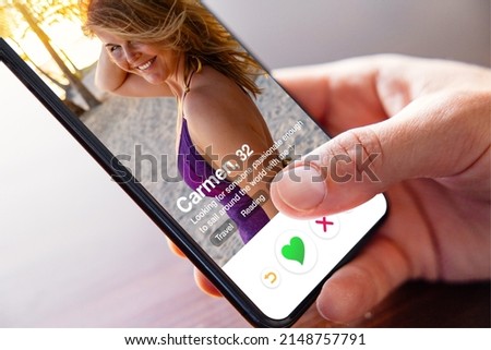 Man using online dating app on phone and viewing someone's profile photo
