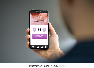 Man Using Online Money Donation Mobile Phone App