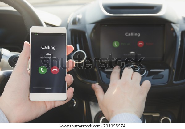Man using phone calling system in car. Hand-free\
safety driving.