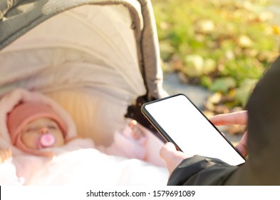 Man Using Phone During Walking With Baby Carriage.