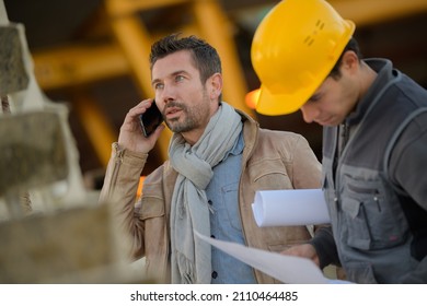 Man Using Phone Outside A Factory