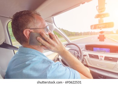 Man using phone while driving the car. Risky driving behaviors concept