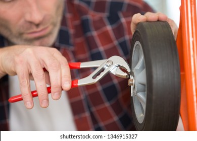 Man Using Pliers To Place A Split Pin