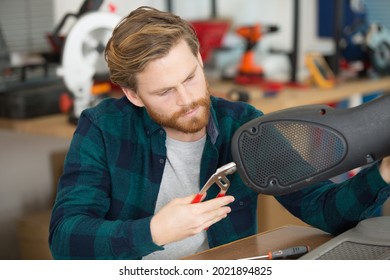 Man Using Pliers In The Workshop