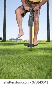 Man Using A Pogo Stick