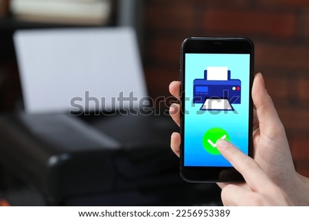 Man using printer management application on mobile phone indoors, closeup and space for text
