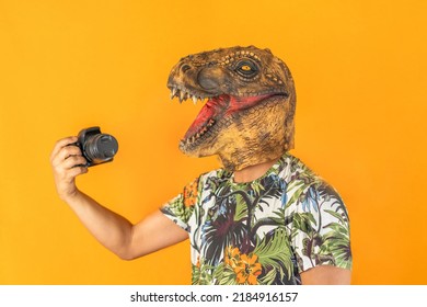 Man Using Professional Camera Wearing Animal Head Mask Isolated On Yellow Background.Photographer Studio Concept.