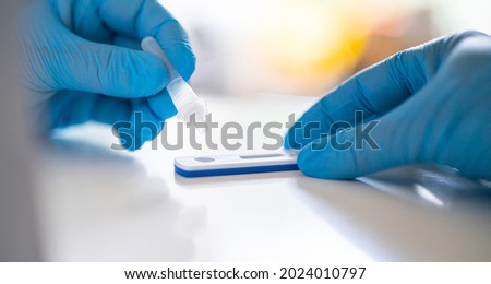 Man using a rapid antigen test kit. Rapid antigen testing is a screening tool to help to detect Corona COVID-19 in people without any symptoms of Sars-CoV-2. selective focus