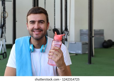 Man Using A Reusable Plastic Water Bottle At The Gym