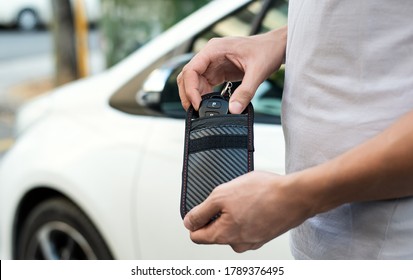 Man Using RFID Protection Pouch For Car Key, Anti-theft RFID Key Pouch.