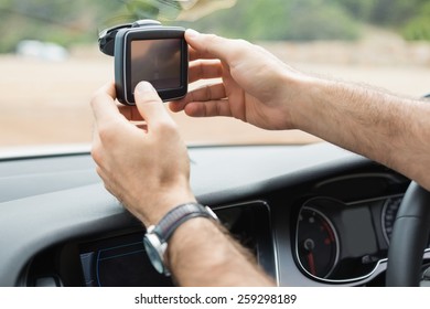 Man Using Satellite Navigation System In His Car