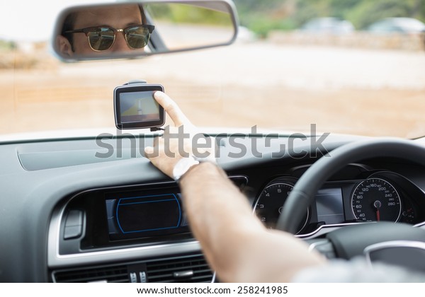 Man using\
satellite navigation system in his\
car