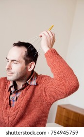 Man Using Scalp Massage Instrument