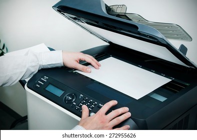 Man Using Scanner Multifunction Device In Office