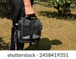 Man USing a Small Shoulder Camera Bag