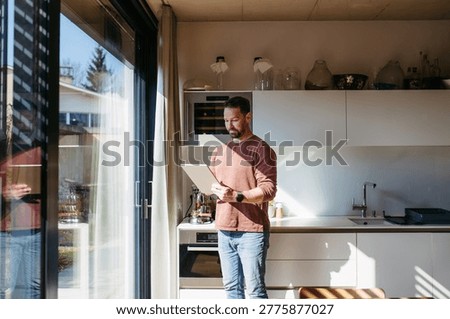 Man using smart home app to control electric window shades indoors.