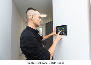 Man using smart home security system control panel