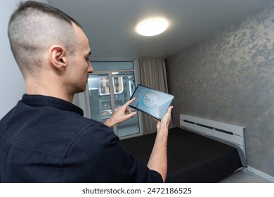 Man using smart home security system control panel