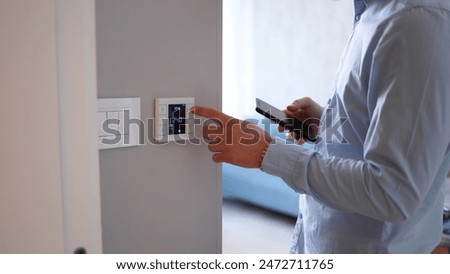 Man using smart home technology at his apartment