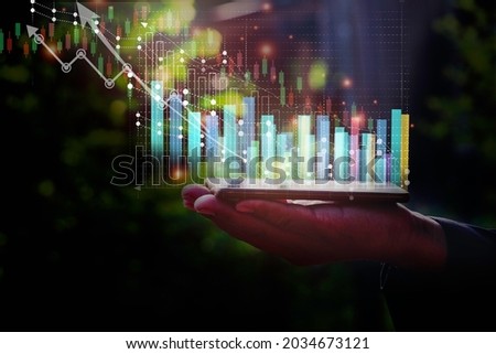 A man using smart phone analyzing graph for data management to make report.Financial technology,Laptop ,many graphs.Investment.Photo concept of Data analyst and financial.