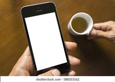 Man using smart phone in cafe. hand holding smart phone white screen.