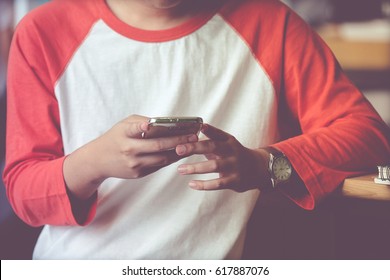 Man using smart phone in cascal lifestyle, vintage tone background