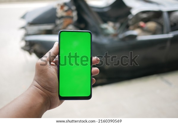 \
man using smart phone with green screen for car service\
