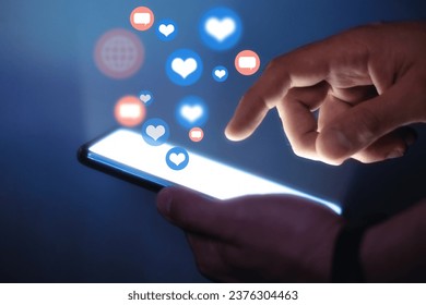 Man using smart phone. Social media concept. Use of social networks, activity on the Internet. Hands with smart phone close up view. Flying social media interaction icon