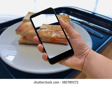 man using smart phone take a breakfast photo before eating or sharing to social network