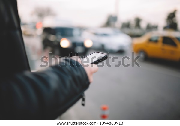 Man using smart phone at\
traffic