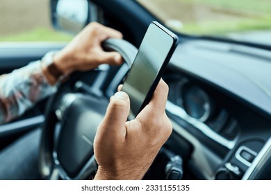 Man using a smart phone while driving a car in the city - Powered by Shutterstock