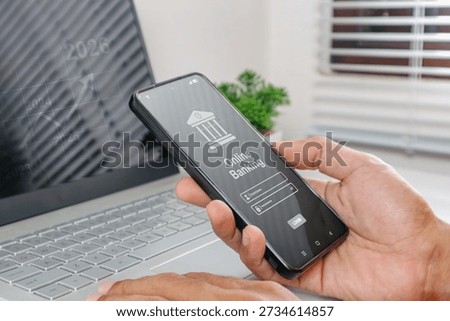 A man using smartphone to access online mobile banking. Enter username and password to access mobile banking.
