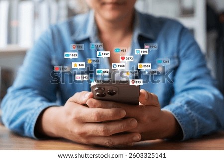 Man using smartphone application accessing social media networks, displaying multiple social media notifications on screen, searching for customers or promoting and advertising online content.