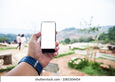 A Man Using Smartphone With Blank Scree On Blurred Nature Background.