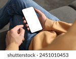 Man using smartphone with blank screen indoors, closeup. Mockup for design