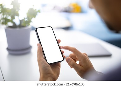 Man using smartphone blank screen frameless modern  - bright home interior - Shutterstock ID 2176986105