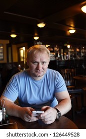 The man using smartphone in a cafe