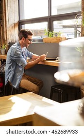 Man using a smartphone in the cafe