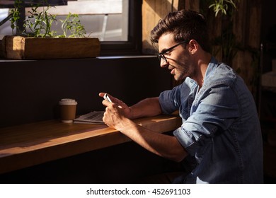 Man using a smartphone in the cafe