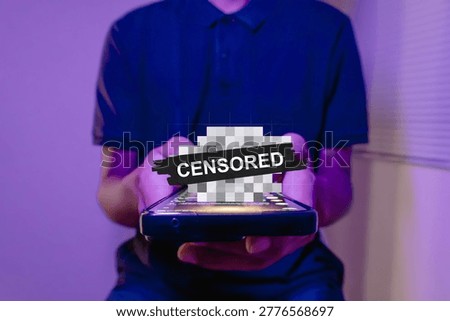 A man using a smartphone with censored content