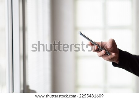 Man using smartphone. Close up of a man holding smartphone. Male hand holding smartphone