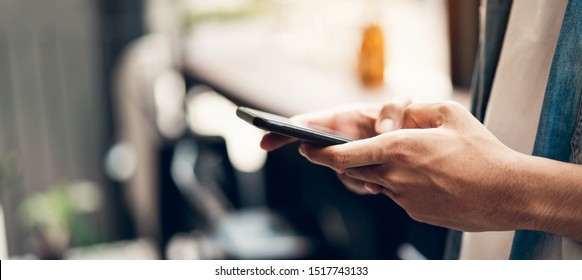 Man Using Smartphone, During Leisure Time. The Concept Of Using The Phone Is Essential In Everyday Life.