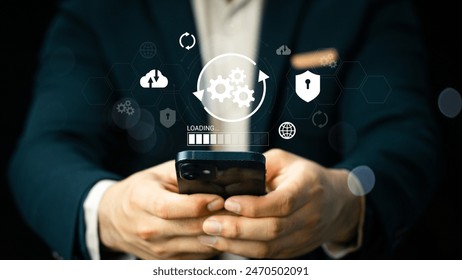 Man using smartphone to install software update. Software update or operating system upgrades to keep your device up to date with enhanced functionality in new versions and improved security.