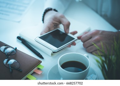 Man using smartphone in office