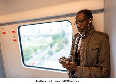 Man using smartphone on train.