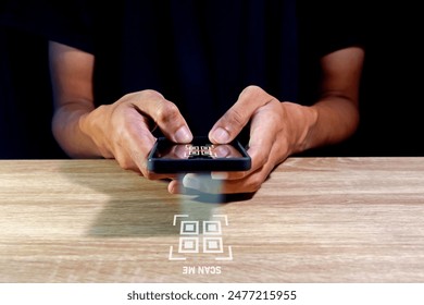 Man using a smartphone to scan QR code. QR code payment, registration, E-wallet or cashless technology concept.