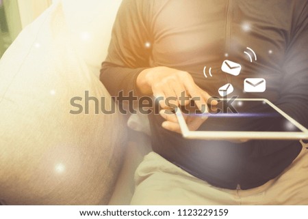 Man using smartphone to send and recieve email for business in cafe background.