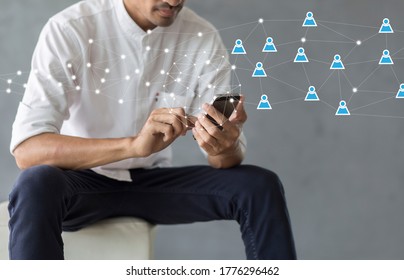 Man using smartphone with social network, teamwork and community concept - Shutterstock ID 1776296462