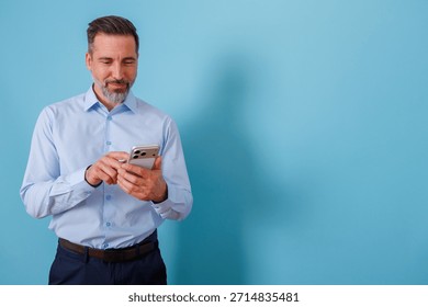 Man using smartphone for texting and digital communication. Professional male smiling, browsing social media or business applications